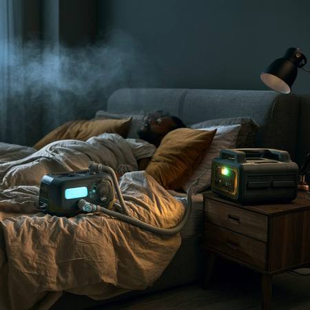 CPAP machine connected to battery station on nightstand — running through a 2 AM power outage