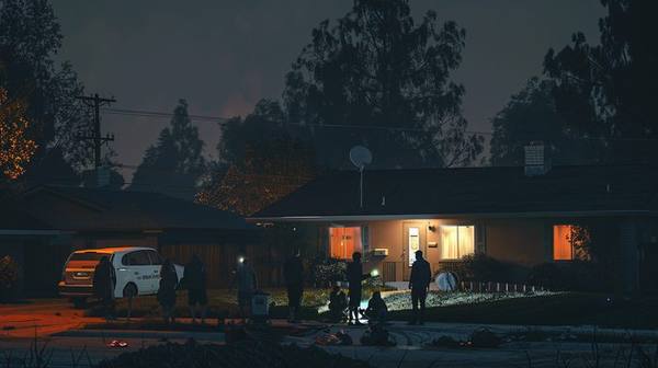 Neighbors gathered on one lit lawn after hurricane with satellite dish visible on roofline — one Starlink serving the whole block